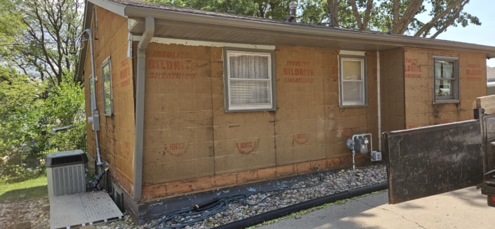 Removing two layers of siding.