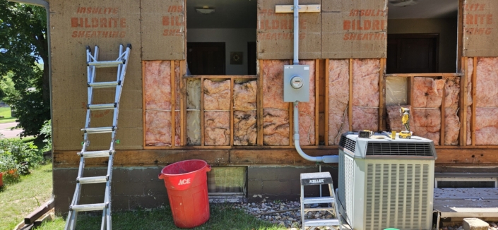 Removing water damaged insulation.