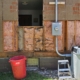 Removing water damaged insulation.