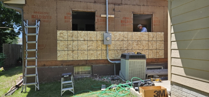 Removing water damaged sheeting.